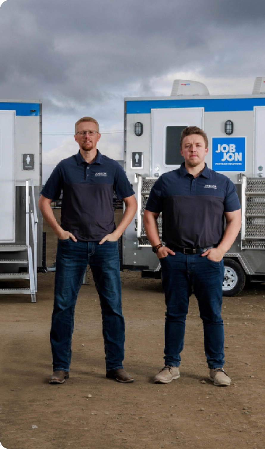 Worker walking past a job site portable toilets unit.